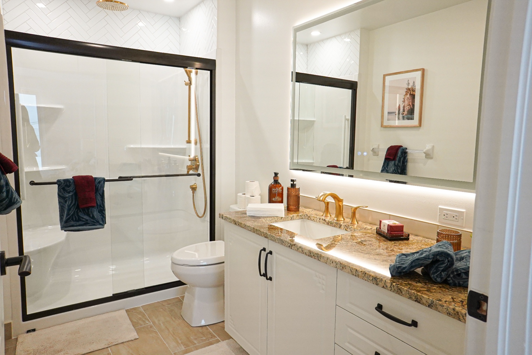 Ensuite — walk-in shower, gold fixtures, granite vanity