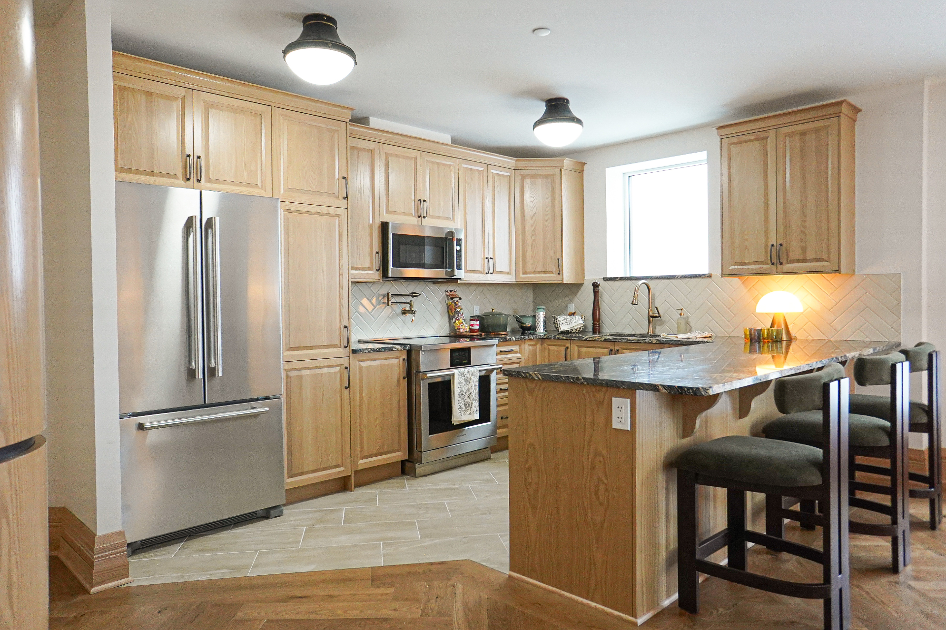 Kitchen — natural wood cabinetry, granite counters, pot filler